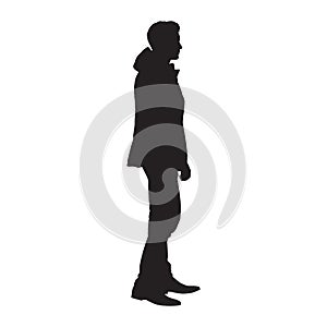 Standing man in winter jacket, isolated vector silhouette. Side view