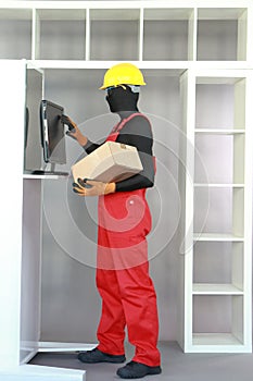 Standing manual worker dealing with box in distribution center.