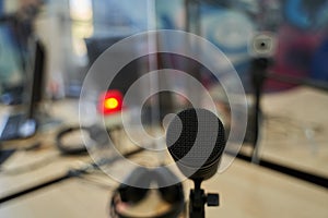 Standing at Microphone in OnAir Radio Studio photo