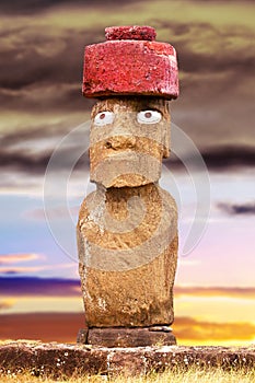 Standing moai with red stone hat and large eyes in Easter Island, Chil