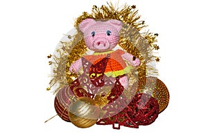 Standing pink pig in the front of the golden christmas wreath wi