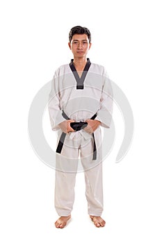 Standing profile of male black belt fighter, full length