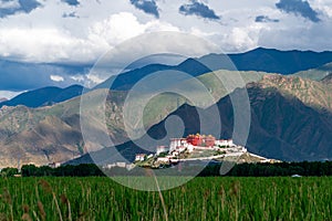 The Potala Palace, the holy place of Tibetan Buddhism under the mountains photo