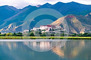 The Potala Palace, the holy place of Tibetan Buddhism by lake photo