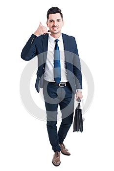 Standing salesman making call me gesture