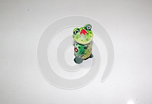 Standing side of a cute frog pottery isolated on white background