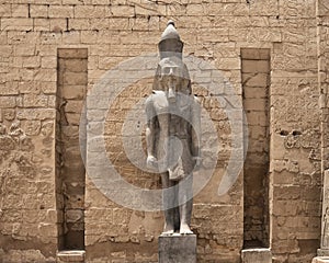 Standing statue of Rameses II at the 1st Pylon, the main entrance for  the Luxor Temple in Luxor, Egypt.