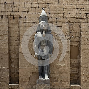 Standing statue of Rameses II at the 1st Pylon, the main entrance for  the Luxor Temple in Luxor, Egypt.