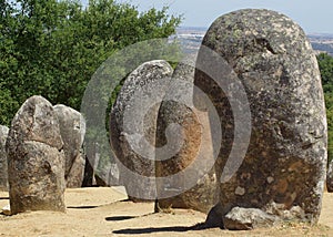 Standing stone megaliths in rows at neolithic site, casting shadows with copy space. photo