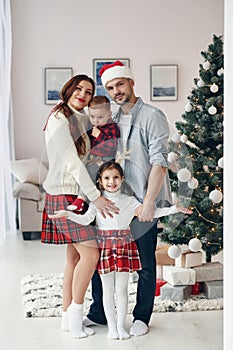 Standing together. Beautiful family celebrates New year and christmas indoors at home