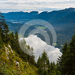 Standing on top of the mountain Planina Blato in the Triglav National Park in Slovenia with panoramic view over the Lake Bohinj