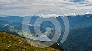 Standing on top of the mountain Planina Blato in the Triglav National Park in Slovenia with panoramic view over the Lake Bohinj