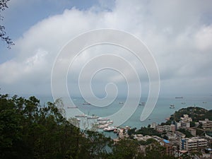 Standing on the top of the mountain to see the small fishing village Clouds and sea on Wailingding Island, Zhuhai City, China