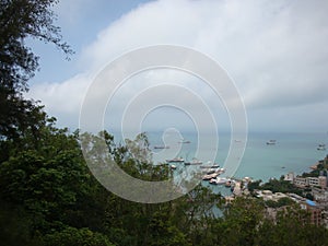 Standing on the top of the mountain to see the small fishing village Clouds and sea on Wailingding Island, Zhuhai City, China