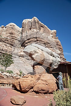 Standing under a falling rock in Arches National Park.