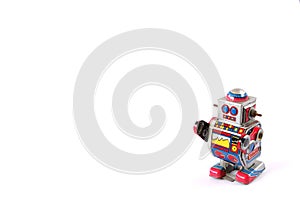 standing vintage tin robot without key on white background space to insert text / word