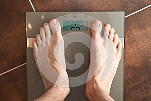 Standing on the weight scale. Overweight / underweight. photo