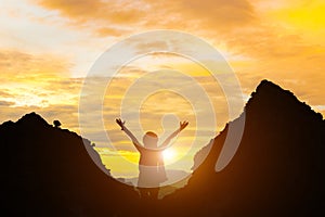 Standing woman holding hand evening sun and mountain silhouette girl stand