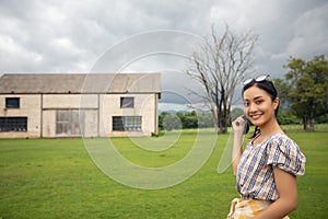 Standing woman holding and smiling happy at the park.