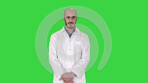 Standing young serious arab doctor on a Green Screen, Chroma Key.