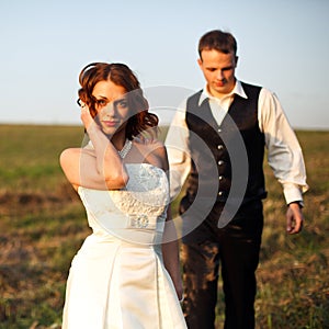 Stands beautifully - bride poses while a groom walks to her on t