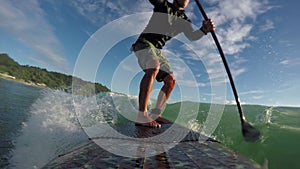 Standup paddle board surfing waves early morning beach