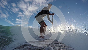 Standup paddle board surfing waves early morning beach