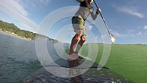 Standup paddle board surfing waves early morning beach