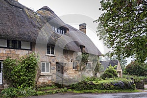 Thatched cottage in the village of Stanton, Cotswolds district of Gloucestershire.  It`s built almost completely of Cotswold stone