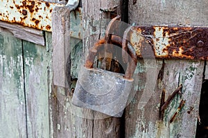 The staple of the broken lock is sawn and hinged on the old wooden door