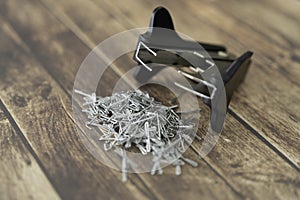 Staple pin remover with pile of staple pins