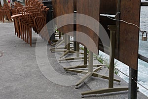 Stapled chairs and tables of a  closed terrace restaurant in Lucerne, Switzerland. Gastronomy establishments are under lockdown.