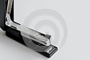 Stapler black with paper clips isolated on white background