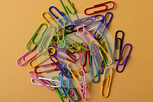 staples paper clip of different colours on yellow