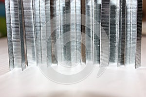 Staples for a stapler are exposed standing on a white background. Staples isolated on a white background