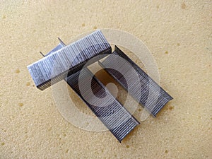 Stapling staples lying on yellow foam photo