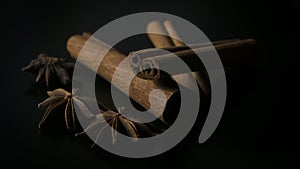 Star anise and cinnamon on black background photo