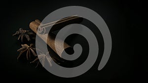 Star anise and cinnamon on black background photo