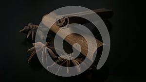 Star anise and cinnamon on black background photo