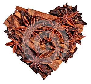Star anise, cinnamon sticks and cloves in the form of heart on a