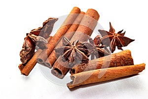 Star anise Illicium verum and cinnamon sticks Canehl close-up isolated on a light background