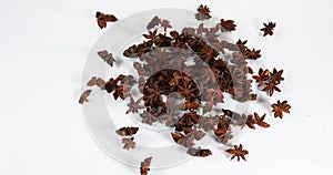 Star anise illicium verum, spice falling against white background, slow motion