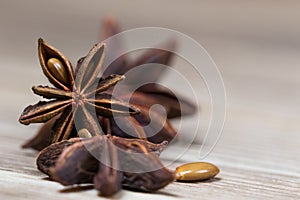 Star anise with and without seeds, closed, on a light wooden surface. spice for the recipe. beautiful picture, background. photo