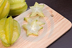 Star apple and averrhoa carambola on wooden block. Fresh star apple fruit on wood table.