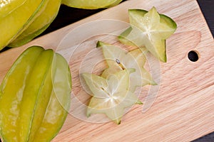 Star apple and averrhoa carambola on wooden block. Fresh star apple fruit on wood table.