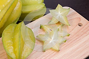 Star apple and averrhoa carambola on wooden block. Fresh star apple fruit on wood table.