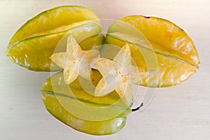 Star apple fruit with half cross section isolated on wooden boar