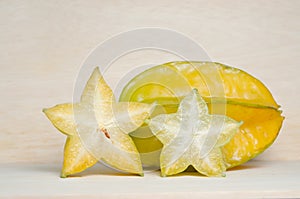 Star apple fruit with half cross section isolated on wooden boar