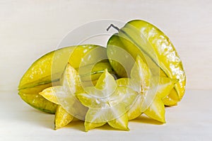 Star apple fruit with half cross section isolated on wooden boar