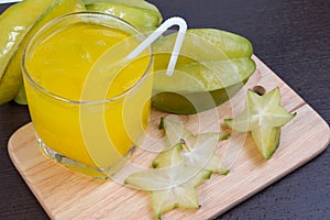 Star apple juice or averrhoa carambola squash on wooden block.